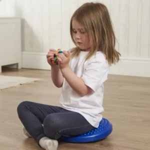 Girl sitting on wobble cushion