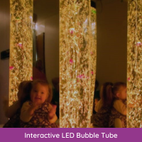 Little girl watching an interactive LED Bubble Tube